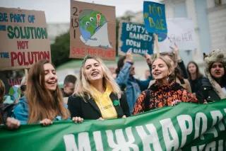 Photo from the International Climate March, where girls hold various posters and shout