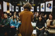 Project author and speaker Tamara Martseniuk is standing in front of event visitors