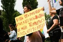 An Equality March participant with a poster “Be careful with those you hate: it may turn out somebody you love”