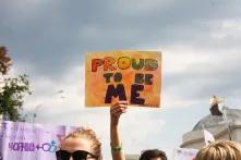 An Equality March participant with a poster "Proud to be me"