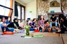 Participants of Green Academy 2019 are sitting or lying on sleeping mats and listening to a lecture