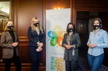 WECU participants and conference speakers near the roll-up