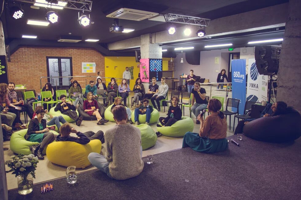 Participants present in the room during the Climate Justice Workshop and speakers on the stage