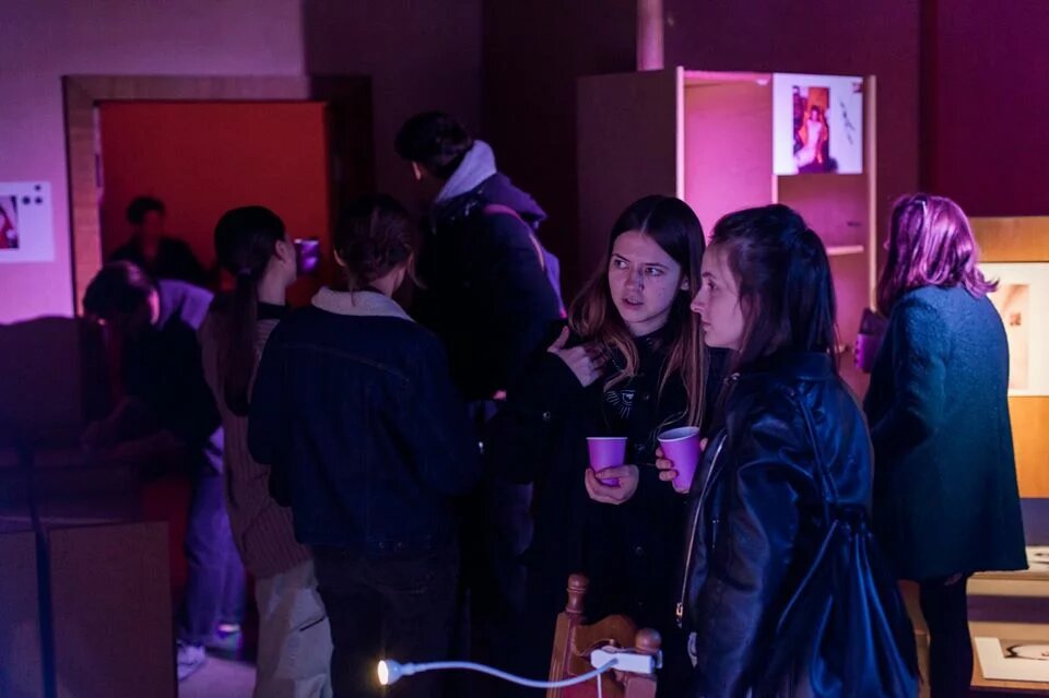 Two young women look at the exhibits and discuss them