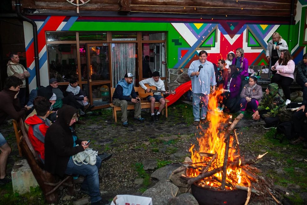 Green Camp participants gathered around the fire