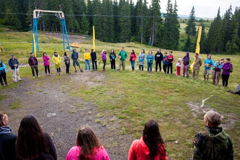 Green Camp participants standing in a big circle