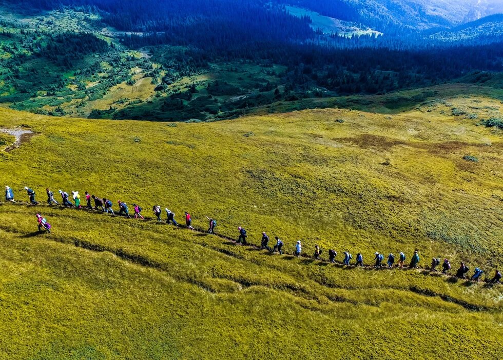 Green Camp participants are hiking on a mountain