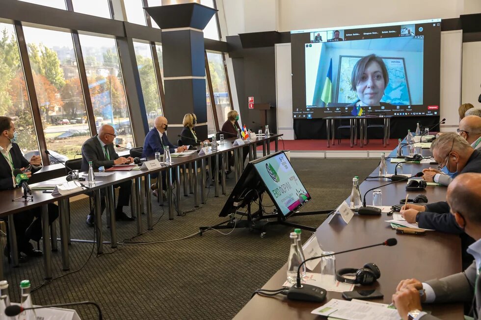 Panelists sit at a table and discuss climate policy