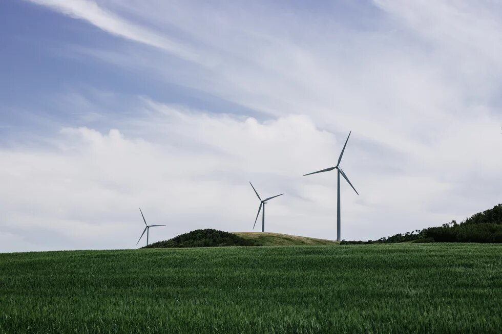 Wind power plants on a green hill